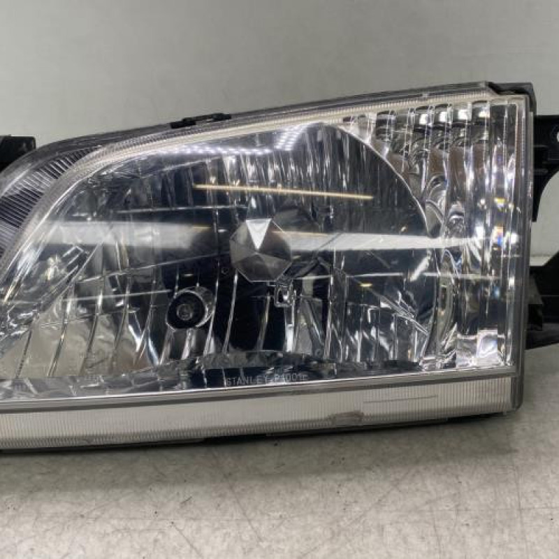 Optique avant principal gauche (feux)(phare) MAZDA DEMIO Photo n°1